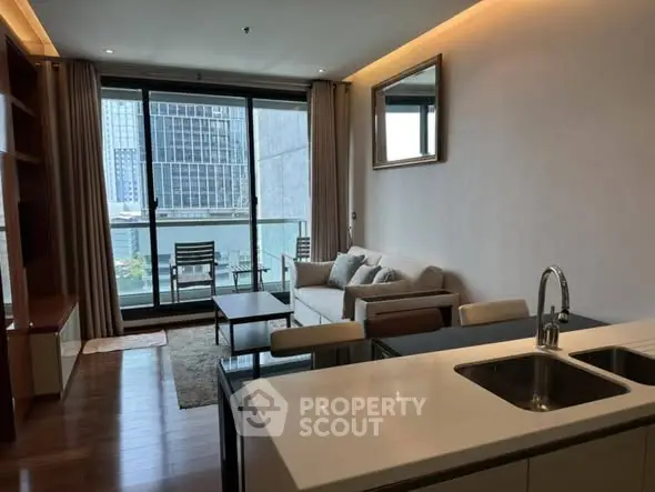 Modern living room with city view, open kitchen, and stylish furnishings.