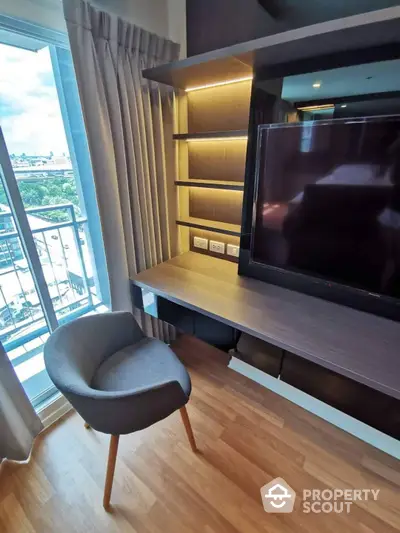 Modern living space with sleek built-in entertainment unit, ample shelving, and cozy seating by the window, offering a blend of comfort and style.