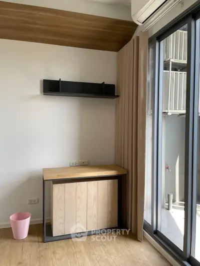 Modern study nook with wooden desk and balcony view, perfect for productivity and relaxation.