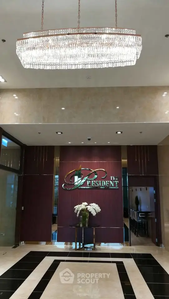 Luxurious building entrance with elegant chandelier and stylish decor