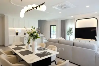 Luxurious open-plan living room with elegant dining area and modern decor