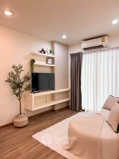 Modern living room with sleek TV setup and cozy decor