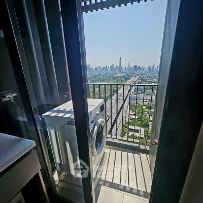 High-rise balcony with washing machine and stunning city skyline view.