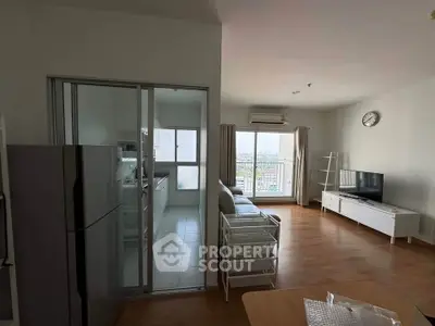 Modern apartment with open living room and kitchen, featuring a balcony with city view.