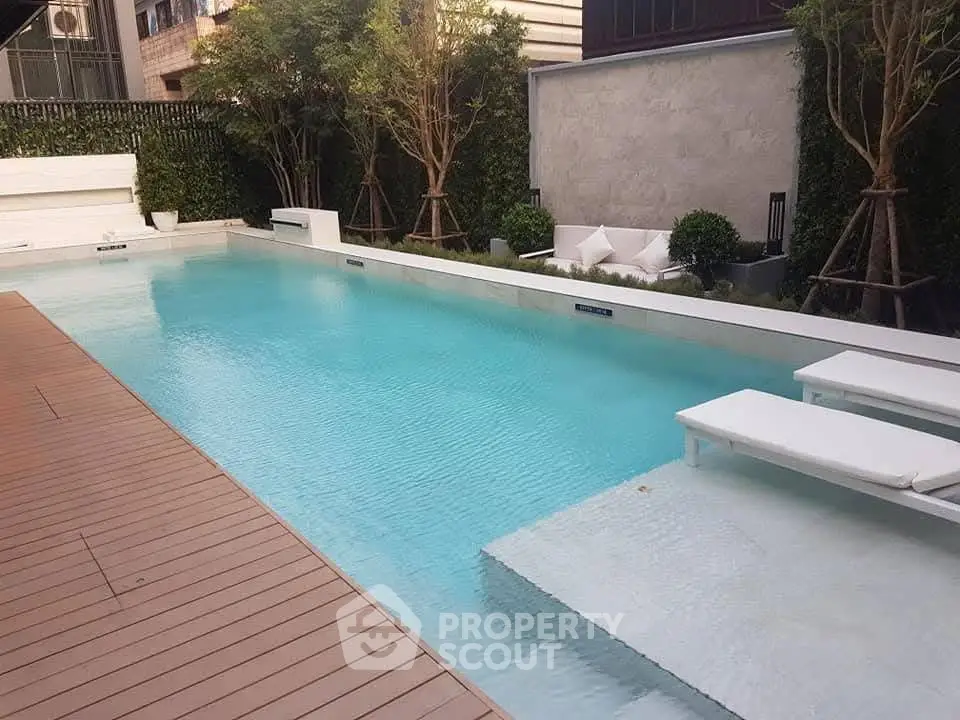 Luxurious outdoor pool area with modern design and lush greenery