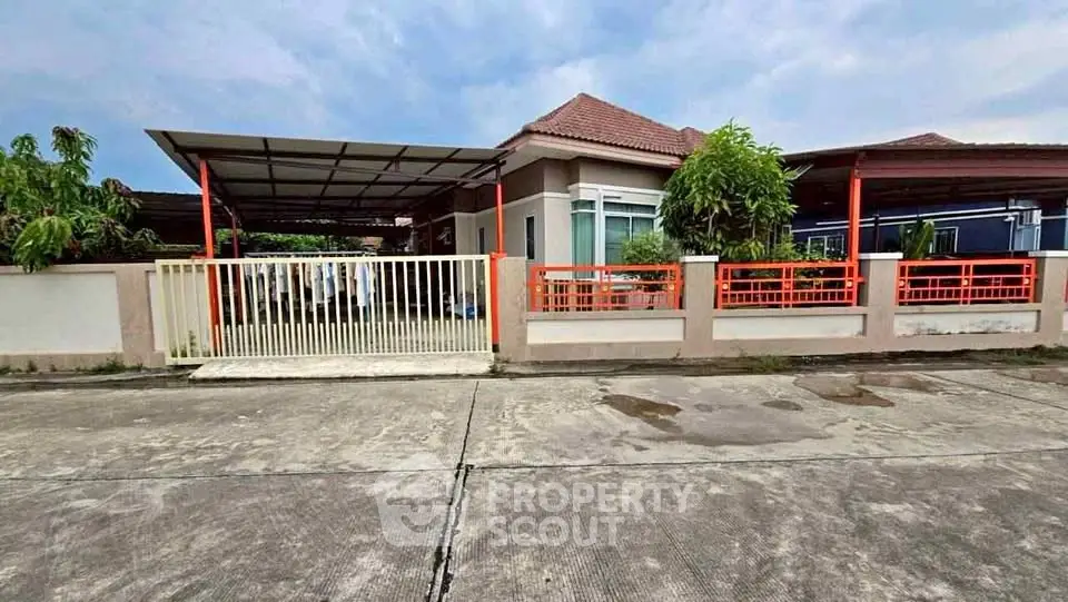 Charming single-story home with spacious driveway and lush greenery, perfect for family living.