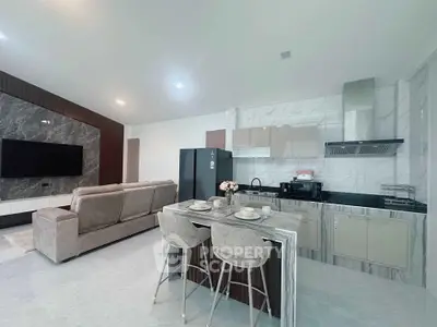 Modern open-concept living room and kitchen with sleek design and stylish furniture.