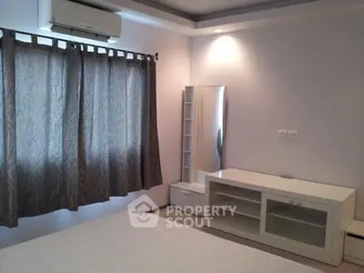 Spacious bedroom with modern furniture and air conditioning, perfect for comfort and relaxation.