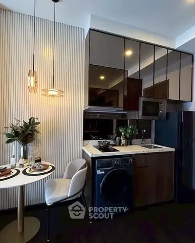 Modern kitchen with sleek cabinetry, integrated appliances, and stylish dining area.