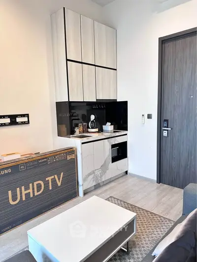 Modern living room with sleek cabinetry and new UHD TV box