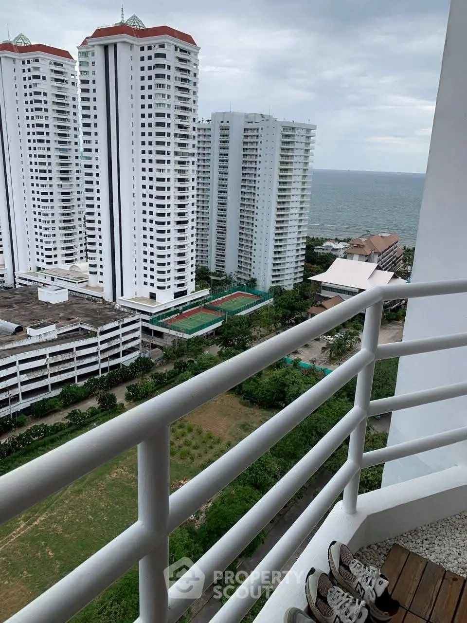 Stunning high-rise ocean view from a balcony in a modern urban setting.