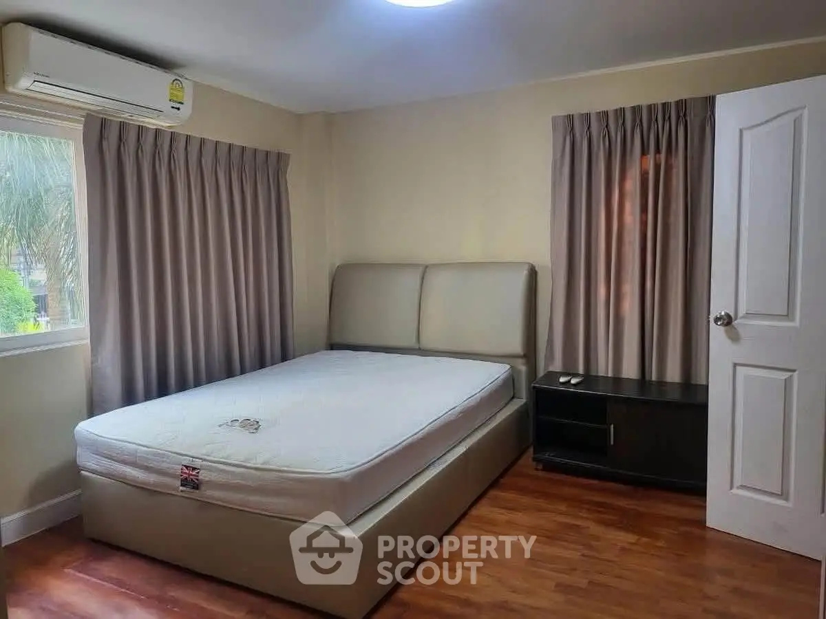 Cozy bedroom with modern furnishings and natural light, perfect for relaxation.