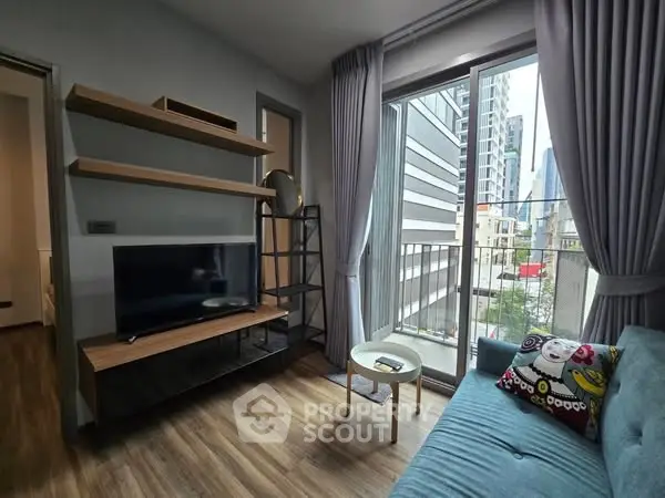 Modern living room with city view, featuring sleek furniture and large windows.