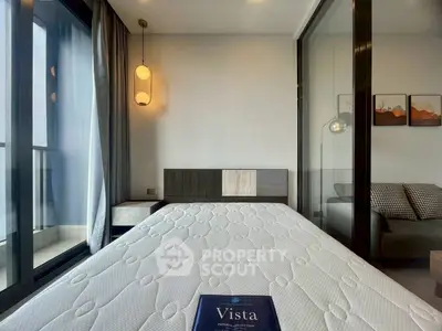 Modern bedroom with balcony access and stylish lighting in a contemporary apartment.