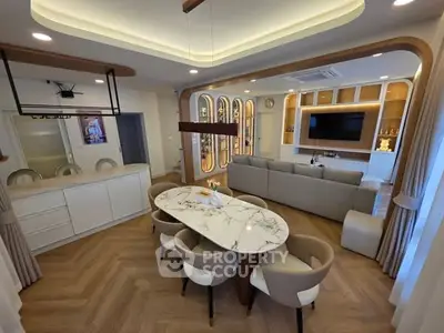 Luxurious open-plan living and dining area with modern furnishings and elegant lighting.