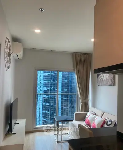 Modern living room with city view, cozy sofa, and stylish decor