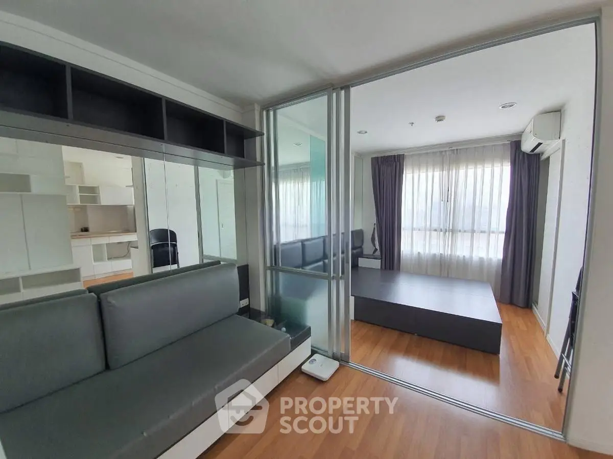Modern apartment interior with glass partition and wooden flooring