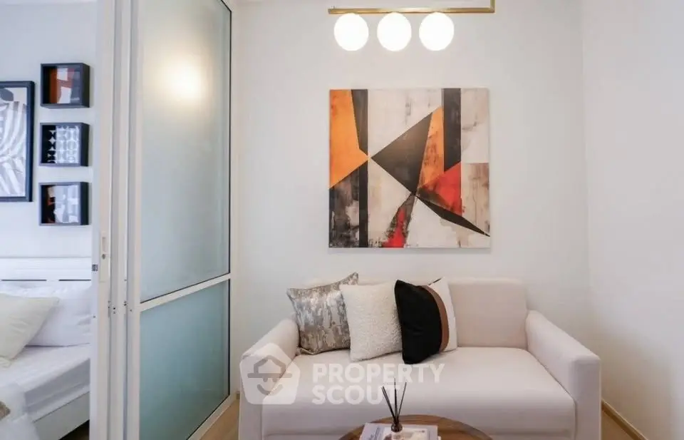 Modern living room with abstract art and cozy sofa in stylish apartment