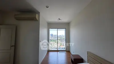 Spacious bedroom with city view and air conditioning in modern apartment