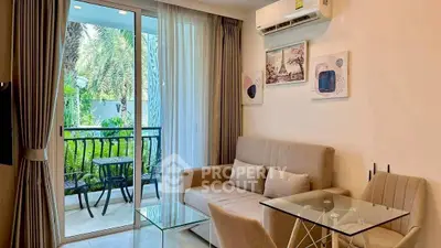 Cozy living room with balcony view, modern furniture, and air conditioning.