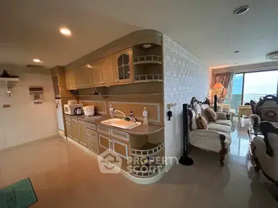 Luxurious open-layout kitchen and living room with elegant furnishings and modern appliances.