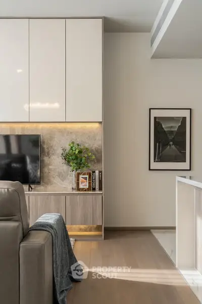 Modern living room with sleek cabinetry, stylish decor, and a cozy ambiance.