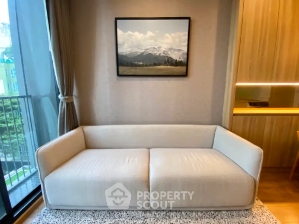 Modern living room with elegant sofa and mountain view artwork