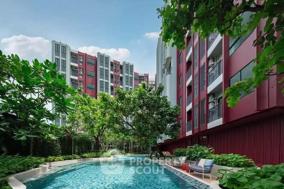 Luxurious apartment complex with a stunning outdoor pool and lush greenery, perfect for relaxation and leisure.
