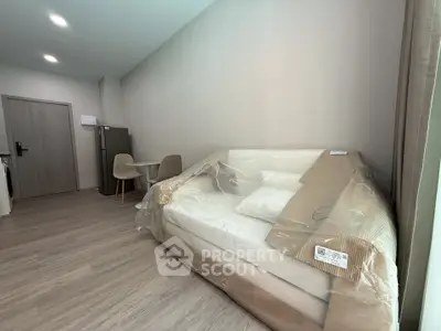 Modern living room with new sofa and dining area in a stylish apartment.