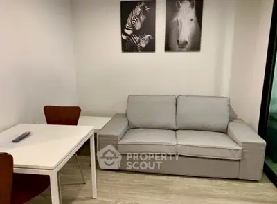 Cozy living room with modern gray sofa and stylish animal artwork, perfect for relaxation.