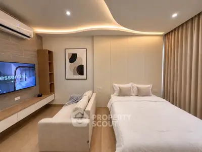 Modern bedroom with stylish decor, cozy bed, and wall-mounted TV in a contemporary apartment.