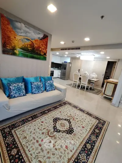 Luxurious living room with elegant decor and open kitchen layout in modern apartment.