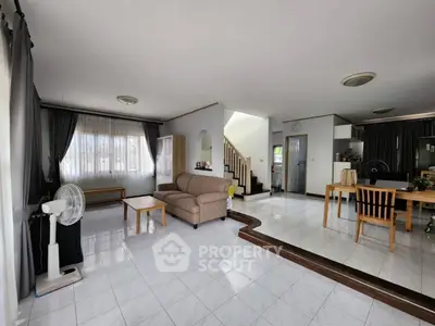 Spacious living room with modern open layout and elegant staircase