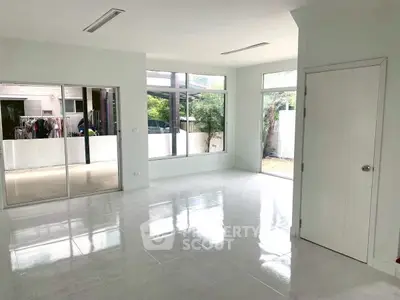 Spacious modern living room with large windows and garden view