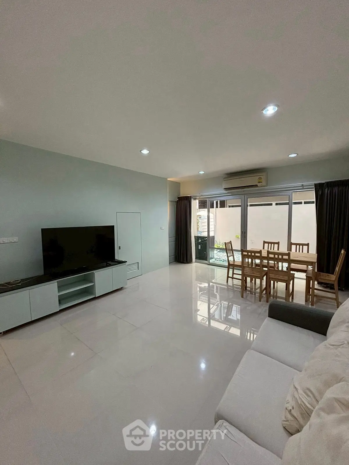 Spacious living room with modern furniture and large windows for natural light.
