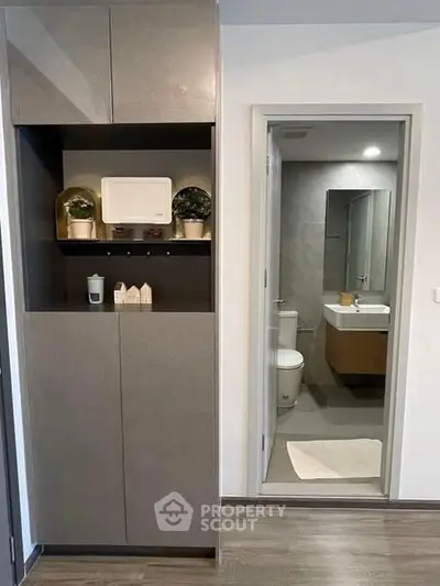 Modern apartment interior with sleek storage and bathroom view