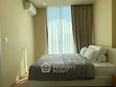 Cozy bedroom with large window and modern air conditioning unit