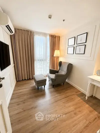 Cozy corner unit with elegant armchair and natural light, perfect for relaxation.