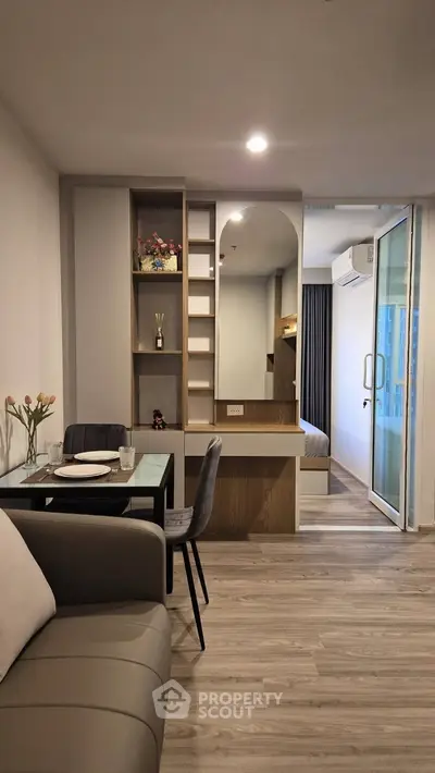 Modern apartment interior with stylish furniture and open layout, featuring a cozy dining area and elegant decor.