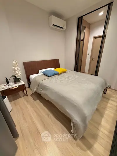 Cozy bedroom with modern decor and air conditioning, perfect for relaxation.