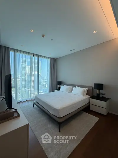 Luxurious bedroom with city view, modern furnishings, and floor-to-ceiling windows in a high-rise apartment.