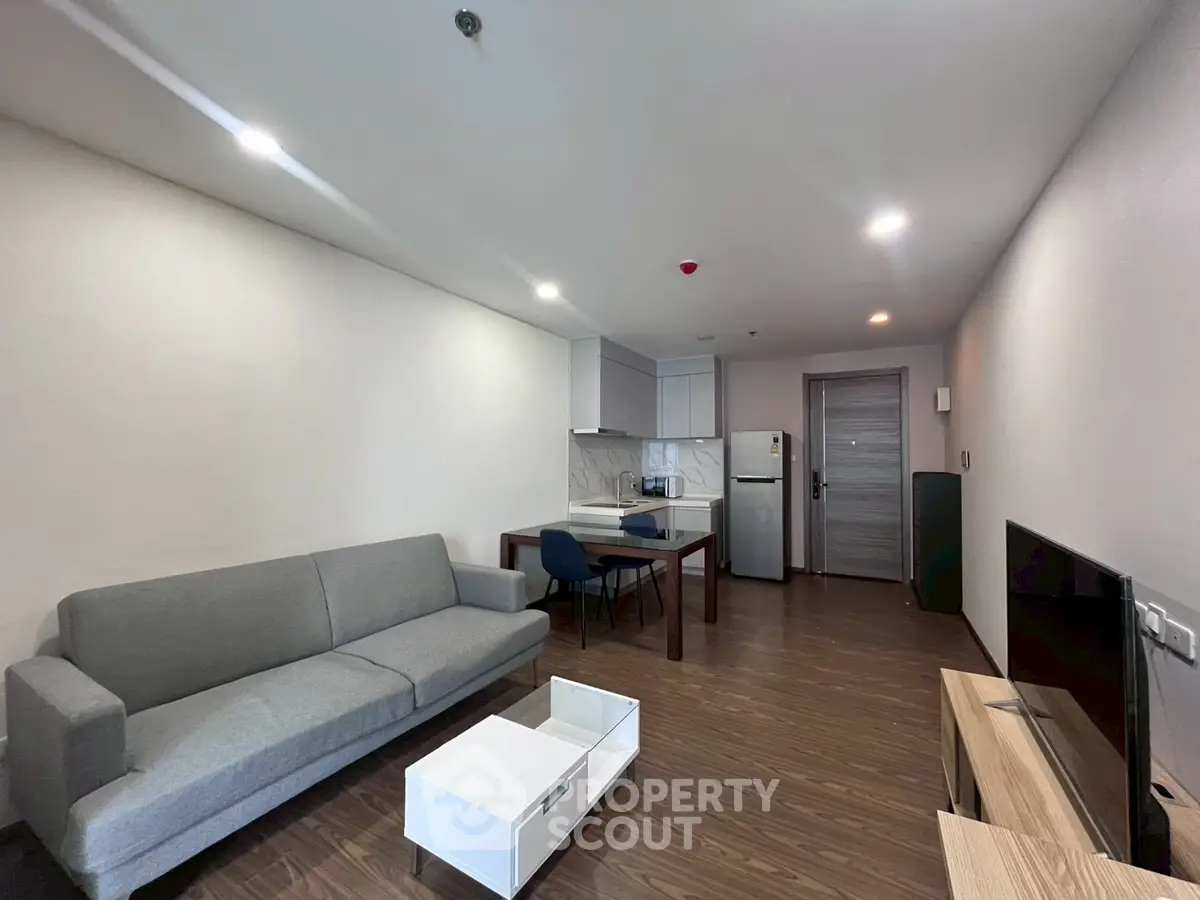 Modern living room with sleek furniture and open kitchen layout