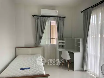 Bright bedroom with modern furniture and large windows in a stylish apartment.
