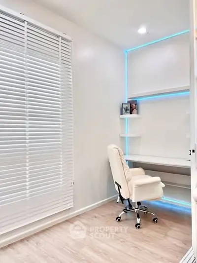 Modern study room with sleek white desk and chair, featuring ambient LED lighting.