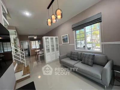 Modern living room with stylish lighting and cozy gray sofa