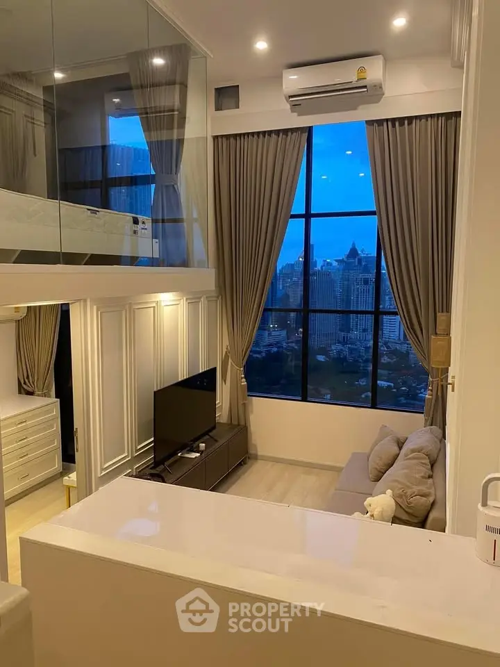 Modern loft apartment with large windows and city view, featuring stylish living area and mezzanine bedroom.