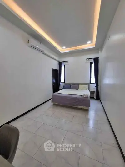 Spacious bedroom with modern lighting and elegant tile flooring