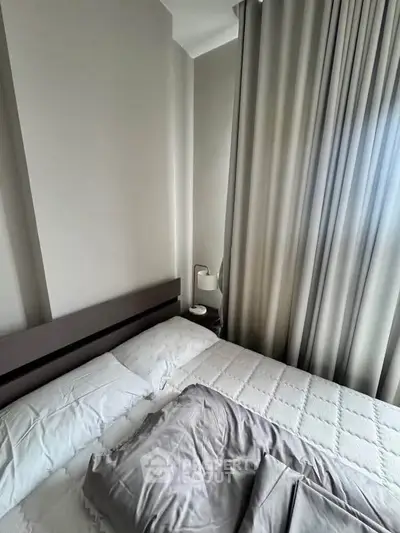 Cozy bedroom with modern decor and soft lighting, featuring a comfortable bed and elegant curtains.