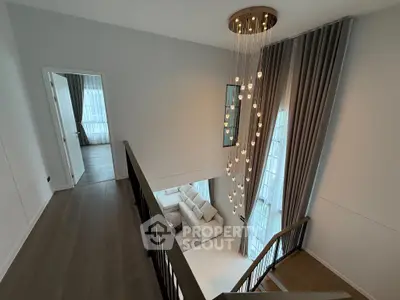 Elegant modern living space with high ceilings and stylish chandelier