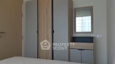 Modern bedroom with stylish wardrobe and mirror in a cozy apartment.